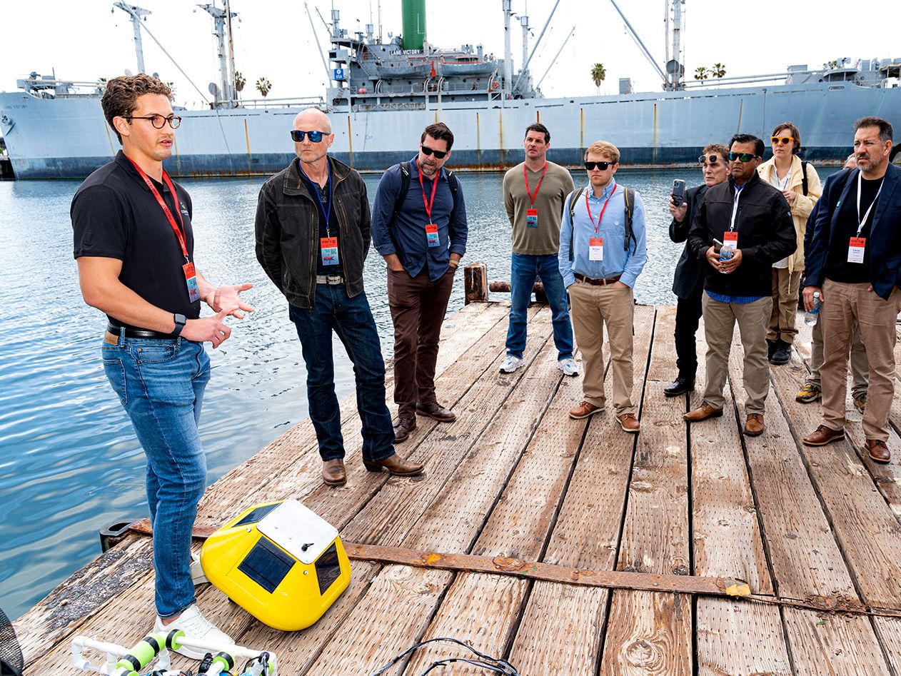 A group of people listens to a new technology presentation at Braid Space at AltaSea